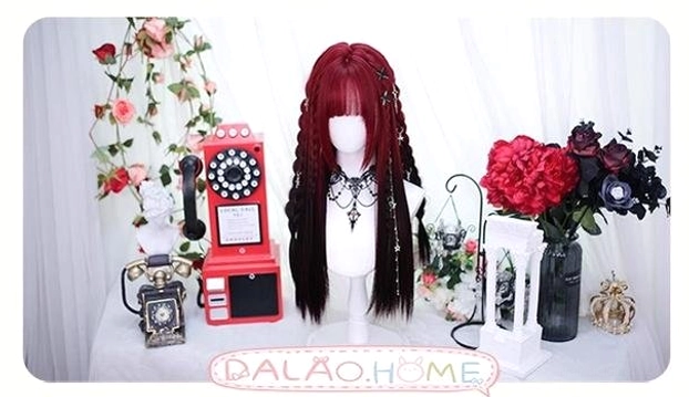 Braided red and black gradient Jirai Kei wig with side braided design displayed on mannequin with floral and retro props, long hair with bangs and brand identification text