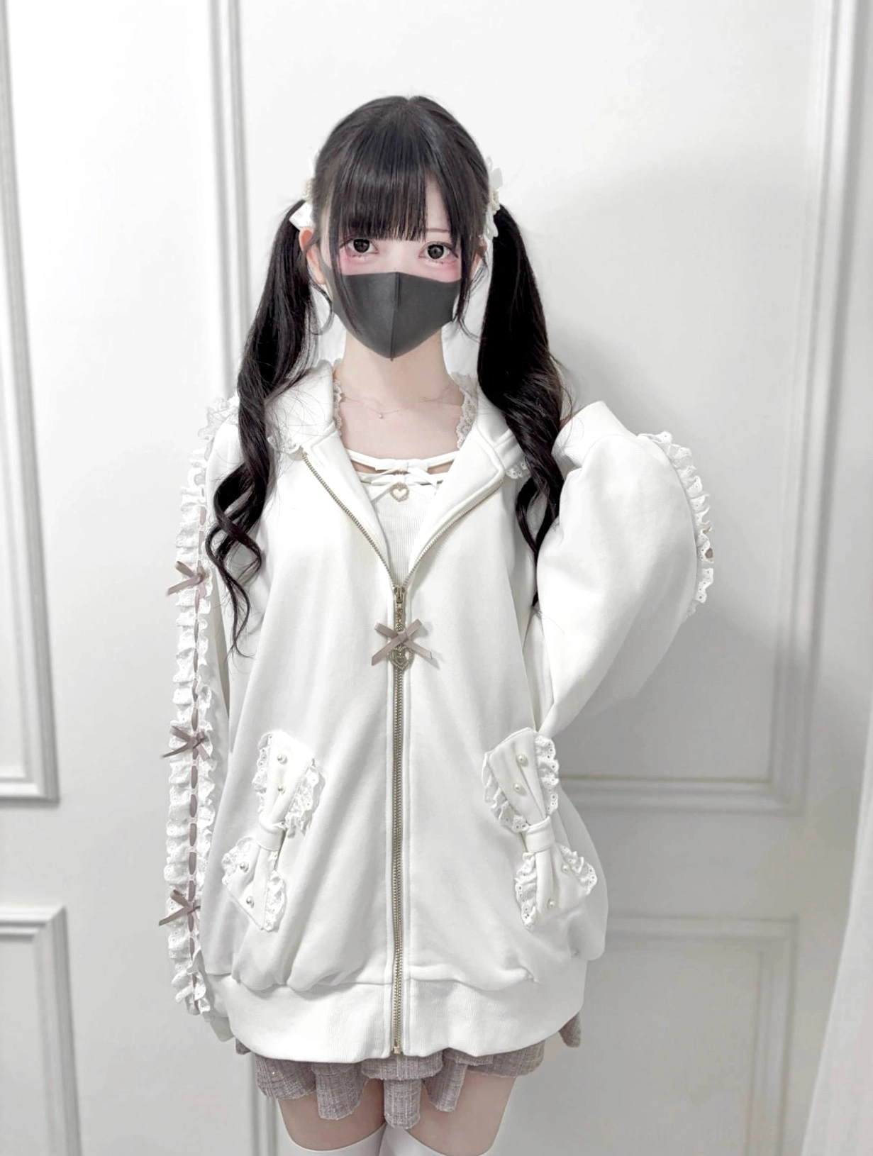 White Jirai Kei zip-up hoodie front full body styling, highlighting ruffled pocket decorations, bow zipper accents, and generous oversized fit proportions