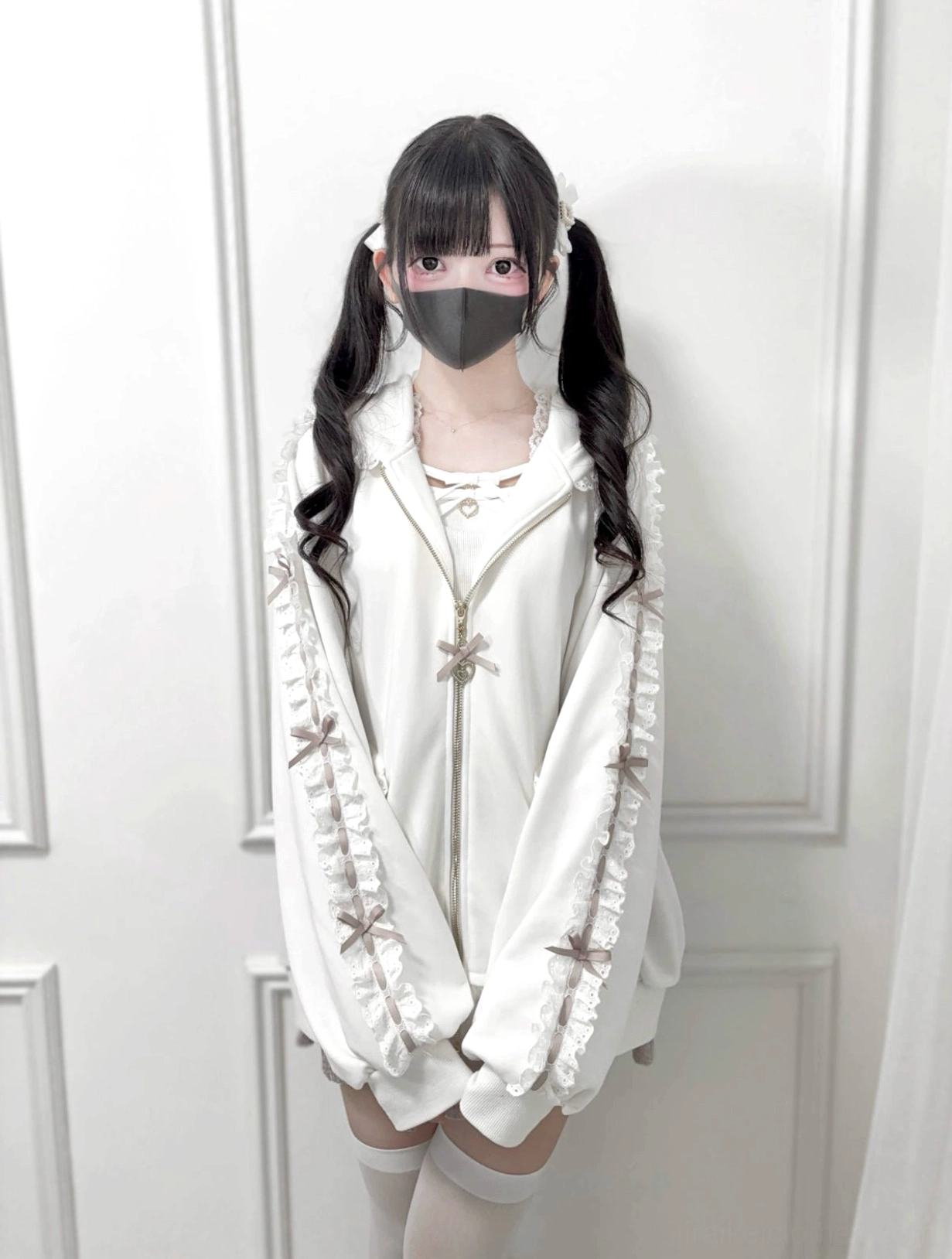 White Jirai Kei zip-up hoodie front view worn by masked model, featuring ribbon bow sleeve trim details and loose oversized silhouette