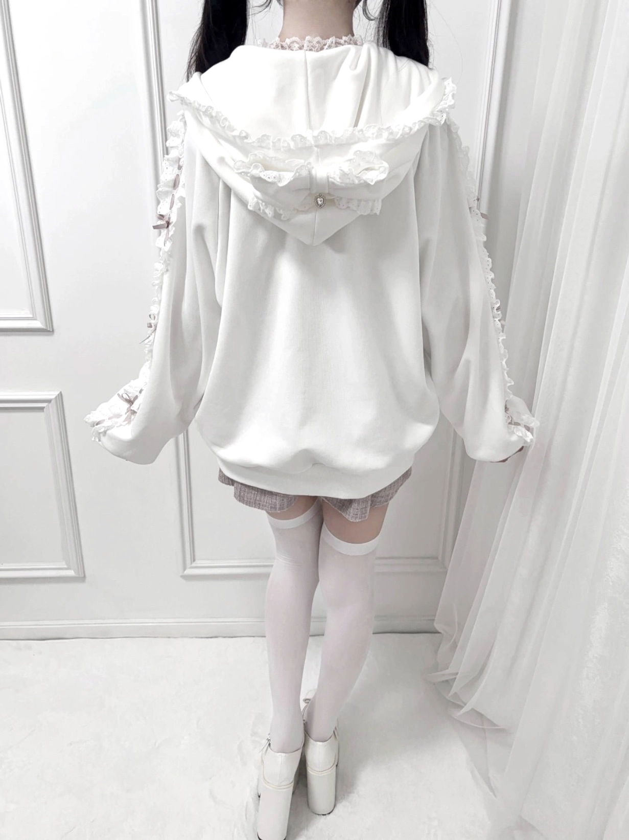 White Jirai Kei zip-up hoodie back full body view, featuring frilled ruffle hood, lace sleeve trim details, paired with checkered mini skirt aesthetic