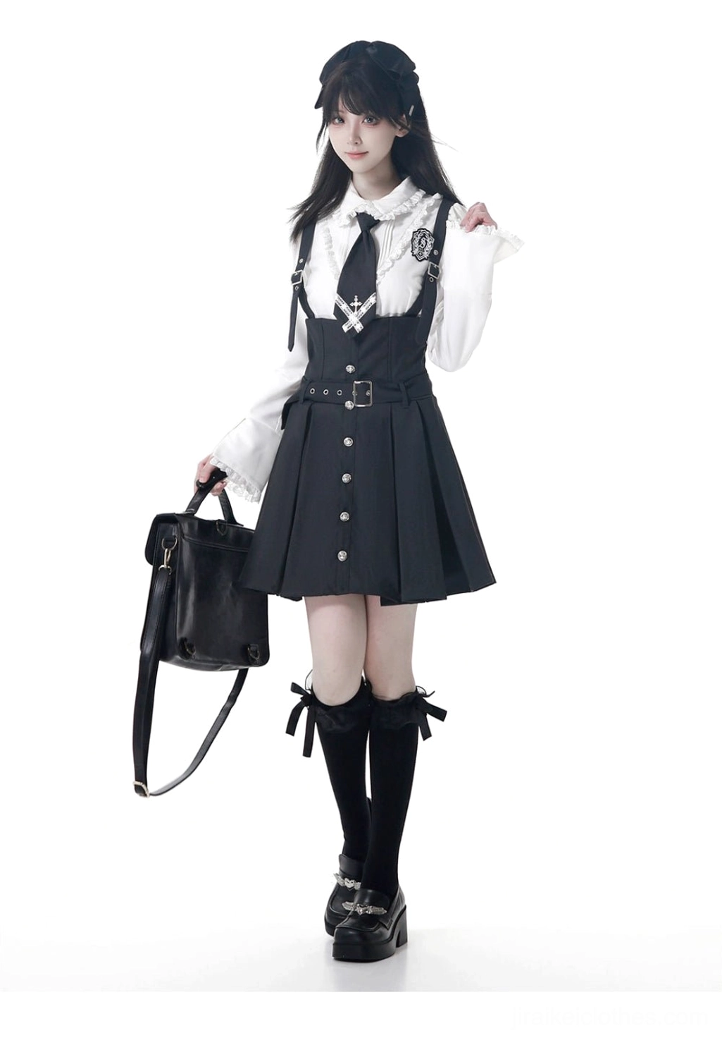 JK blouse and overall dress set front three-quarter angle featuring ruffled fitted blouse, pleated overall skirt with suspenders, necktie badge detail on female model studio background