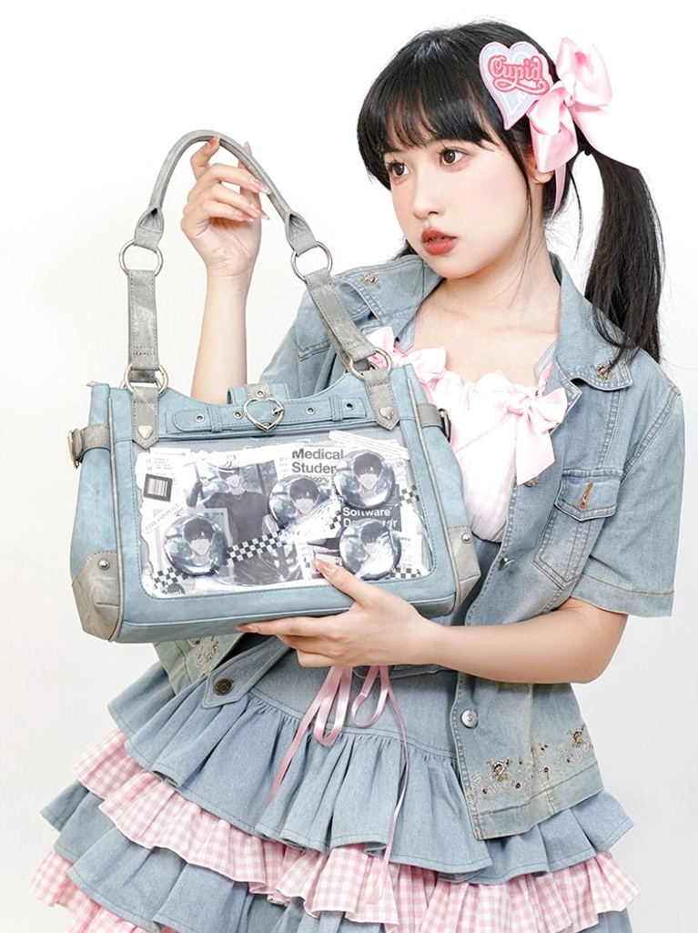 Light blue Jirai Kei ita crossbody bag with clear display window showcasing anime collectibles and pins, highlighting color variation and transparent panel visibility