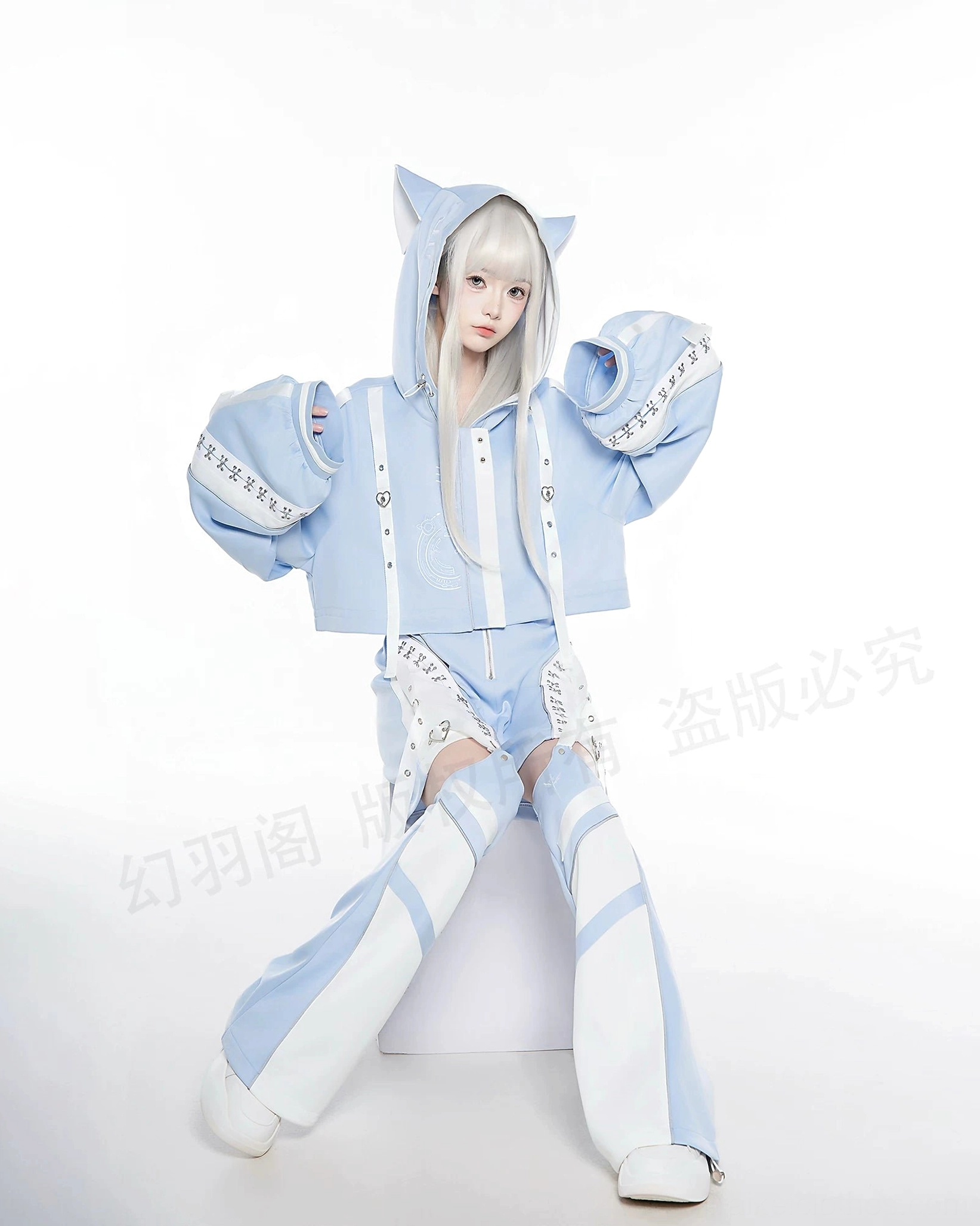 Light blue techwear hoodie set cat ear hood cropped oversized top matching leg sleeves single model full body pose studio