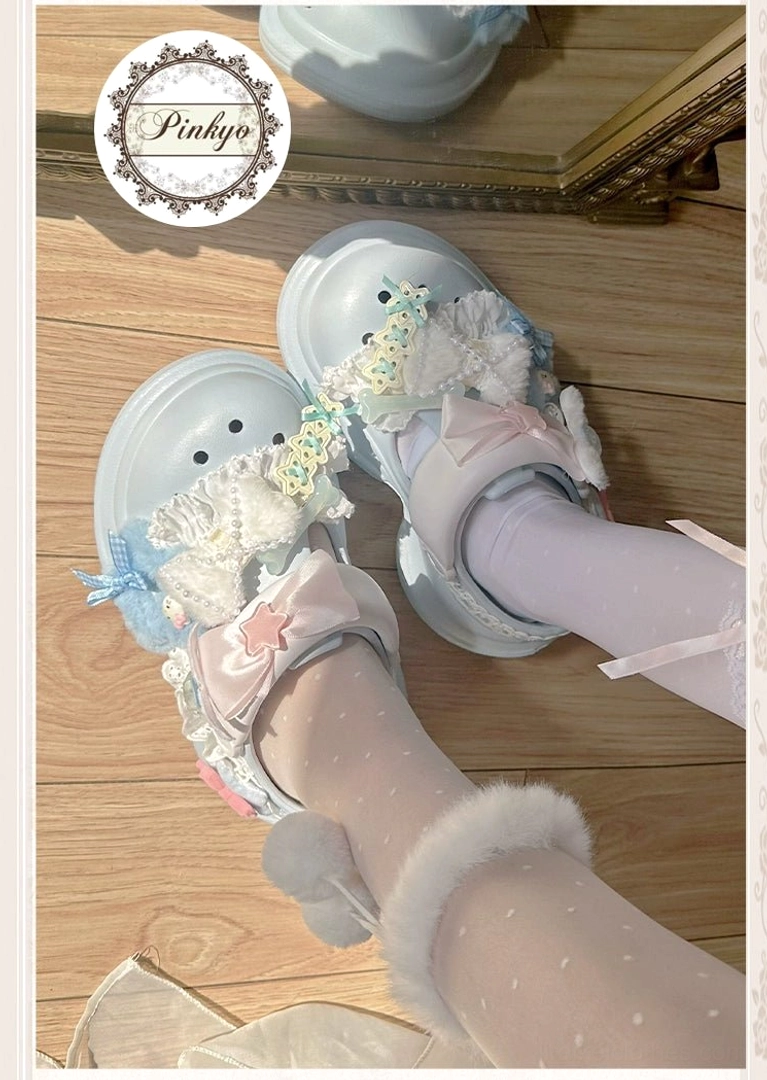 Lolita style Jirai Kei clog sandals with lace embellishment, bow decoration, fuzzy pom-pom details, worn with purple polka-dot socks overhead angle