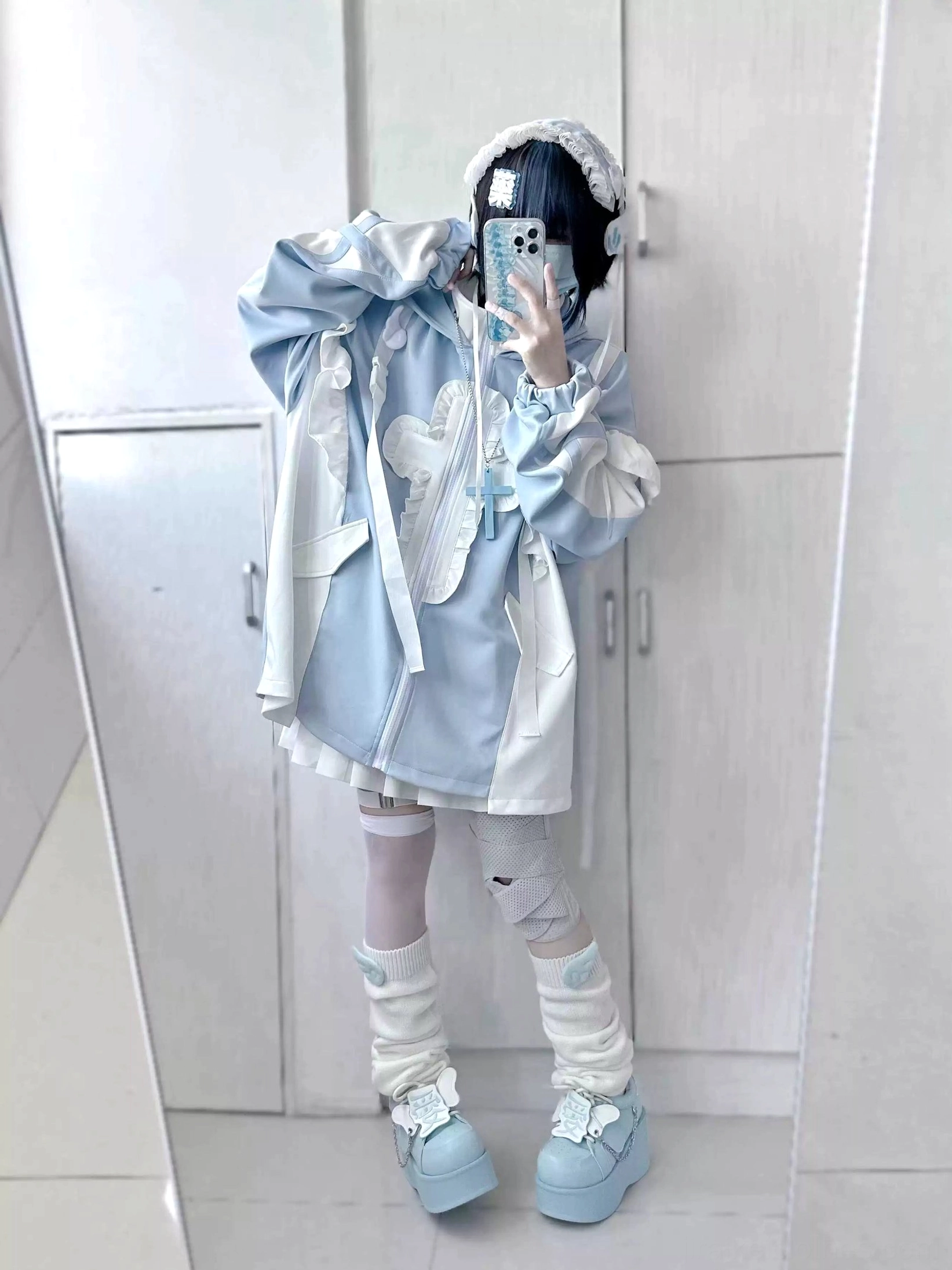 Front full-body coordinate of loose blue tenshi kaiwai coat with cat ear hood, flounced trim, bandaged thigh-highs, leg warmers and layered street style aesthetic