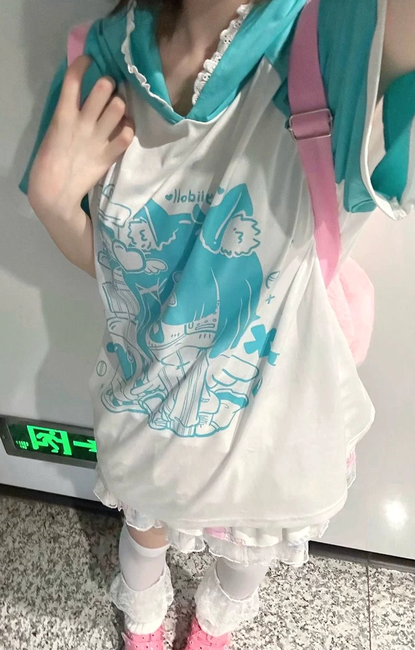 Otaku girl in white and cyan cat ear hooded anime graphic tee with loose fit, partial mirror selfie with pink backpack, paired with ruffle skirt hem and casual subculture accessories