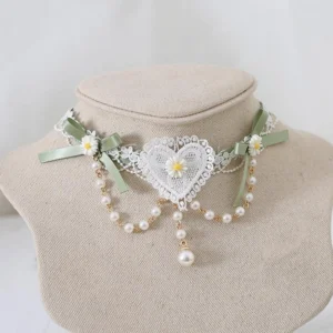 Matcha green Jirai Kei lace choker with white heart details, delicate daisy embellishments, pearl tassel pendant, and gold bead chains—front view on fabric mannequin neck showcasing romantic alternative fashion aesthetic