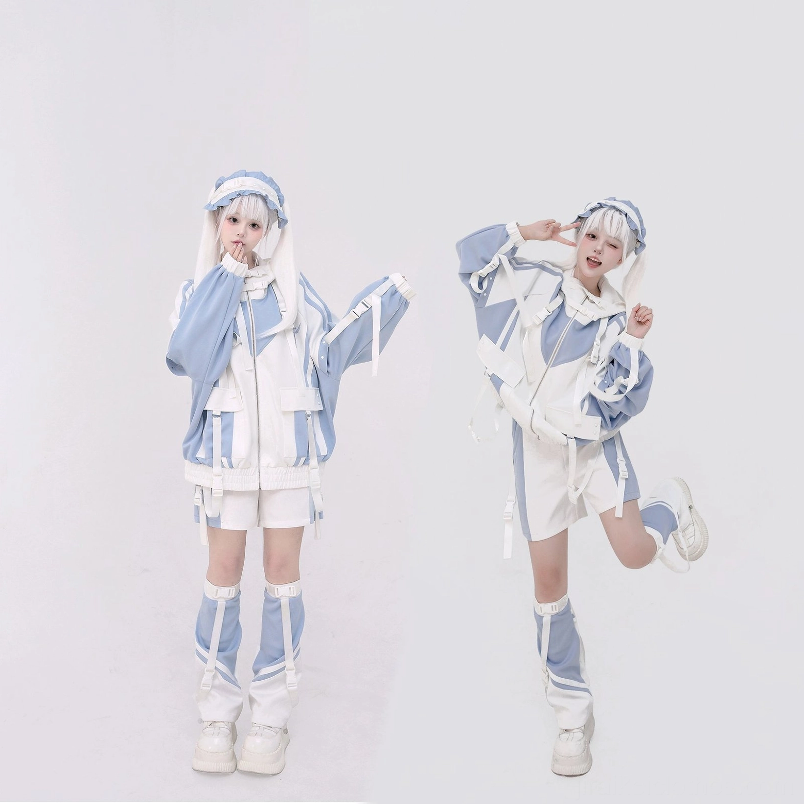 Matching blue-white Jirai Kei sporty coordinate sets on two models dynamic posing studio photography