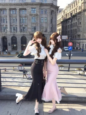 Matching sweet lolita fashion outfits featuring off-shoulder ruffle blouses and high-waisted fishtail skirts on models at urban balcony location
