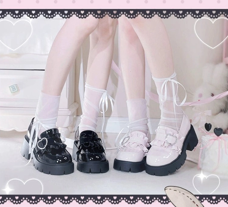 Mixed black and white platform loafers Jirai Kei flat lay foot view heart-lace framed background multiple pairs heart rhinestone buckle details