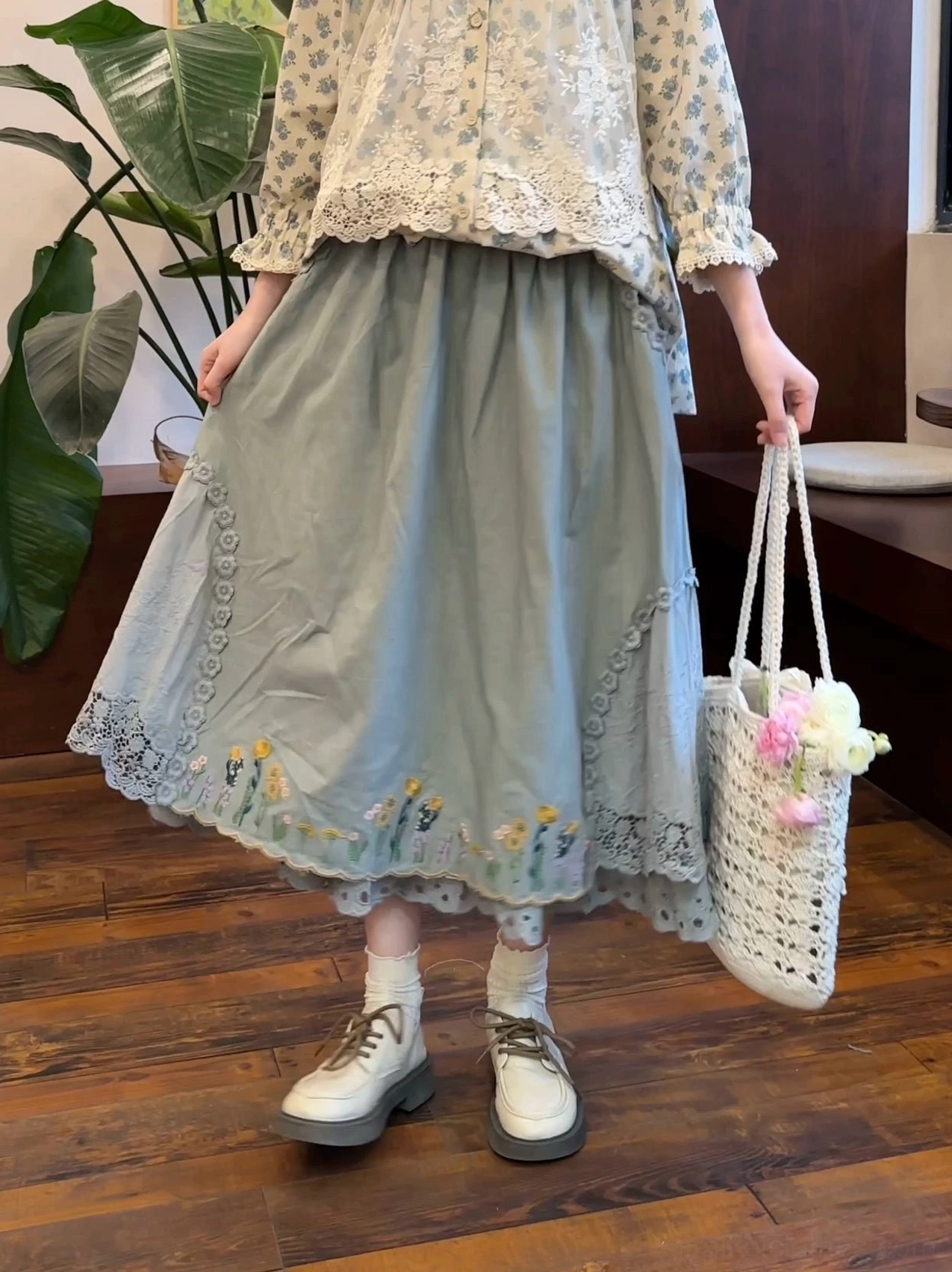 Mori kei embroidered linen skirt detail shot showing floral embroidery and delicate lace trim craftsmanship