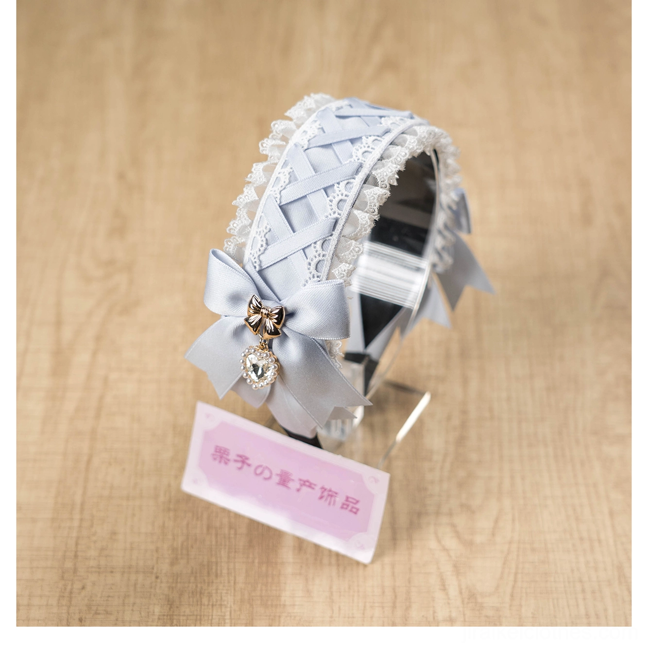Ornate lace Jirai Kei headband detail shot highlighting rhinestone heart pendants, ruffled lace texture, and satin bow embellishments, product photography style showcase of craftsmanship