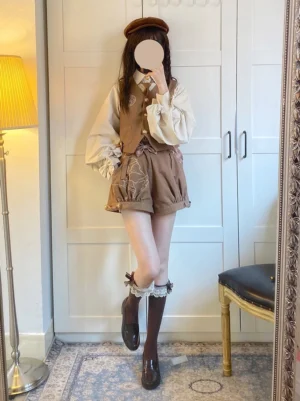 Mirror reflection showing daily wearable Ouji fashion outfit with brown beret, ruffled socks, leather boots and matching embroidered shorts coordination