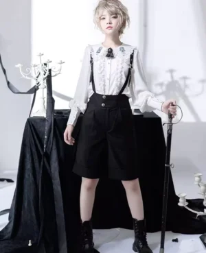Ouji lolita ensemble full front view suspender shorts with decorative brooch buttoned waistband black suspenders formal gothic styling
