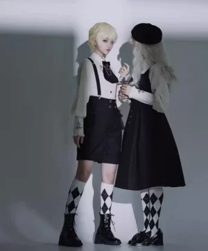 Ouji Lolita couple outfit side-view dark studio background beret argyle patterned socks suspender pieces gothic fashion