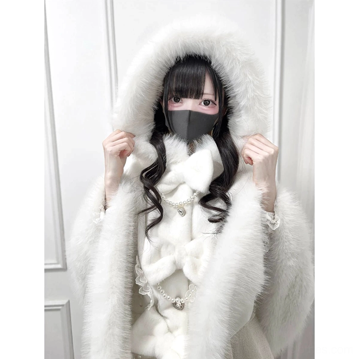 Oversized faux fur hood detail of white Jirai Kei winter cape with pearl chain and bow accents