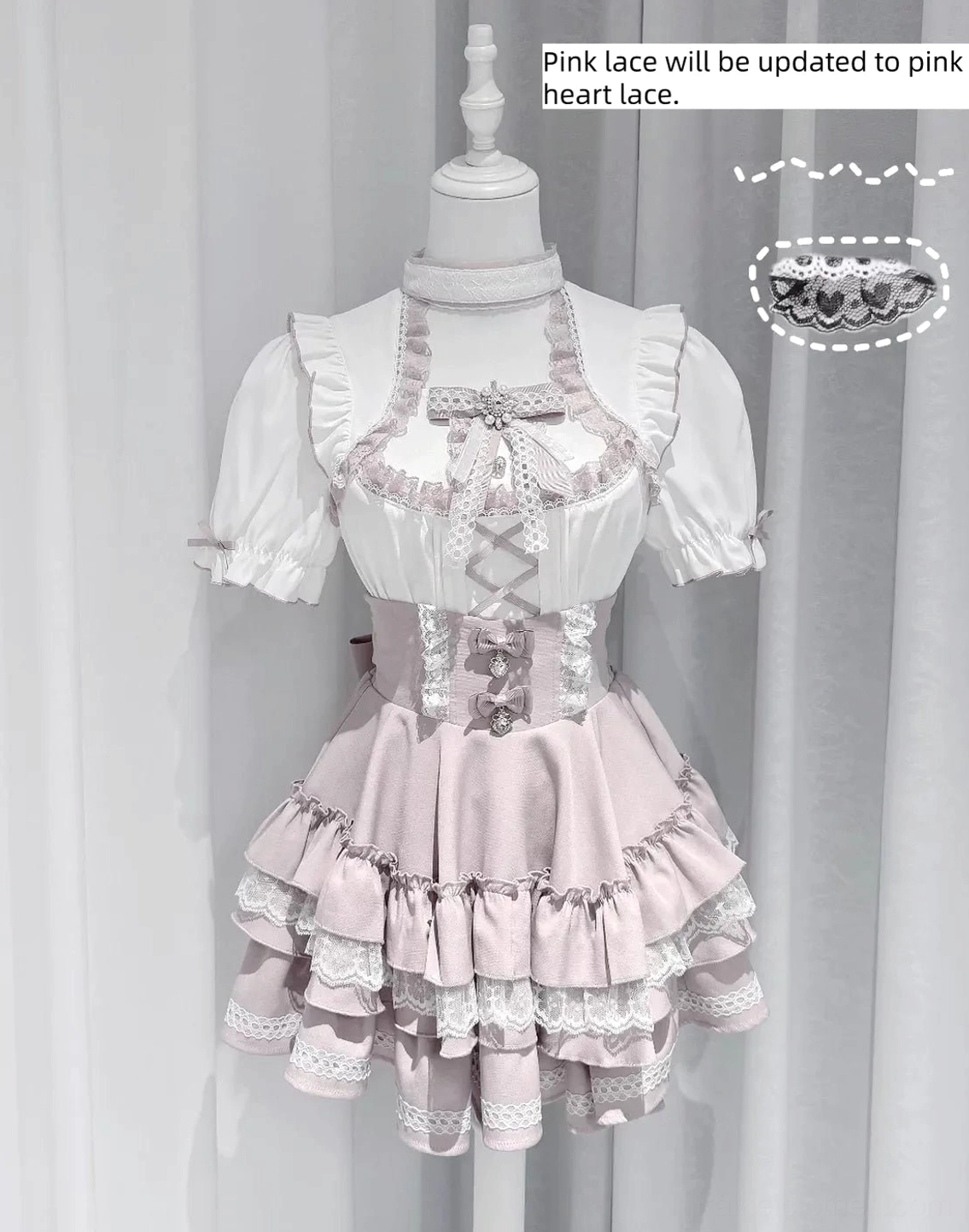 Pink pastel Jirai Kei blouse with lace puff sleeves and tiered ruffle skirt on dress form with product notes