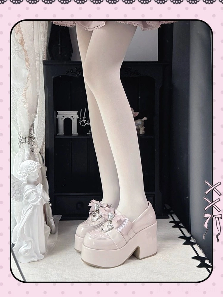 Pastel pink Ryousangata platform loafers with glossy patent finish and chunky platform heel, low-angle side view on-foot with white sheer tights and vintage backdrop