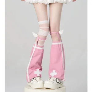 Pink angel wing leg warmers featuring white cross decor wing accents and striped knee bands paired with platform shoes