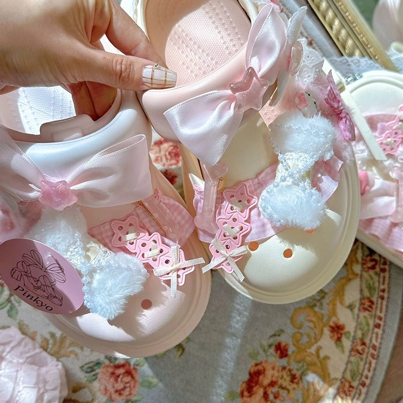 Pink and beige mix-and-match Jirai Kei kawaii clog sandals with adorable cute bow, fuzzy pom-pom accents, lace trim, and pastel platform sole