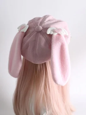 Celestial pink beret back view displaying fluffy detachable bunny ears wing-heart crown ornaments riveted lace strap detail