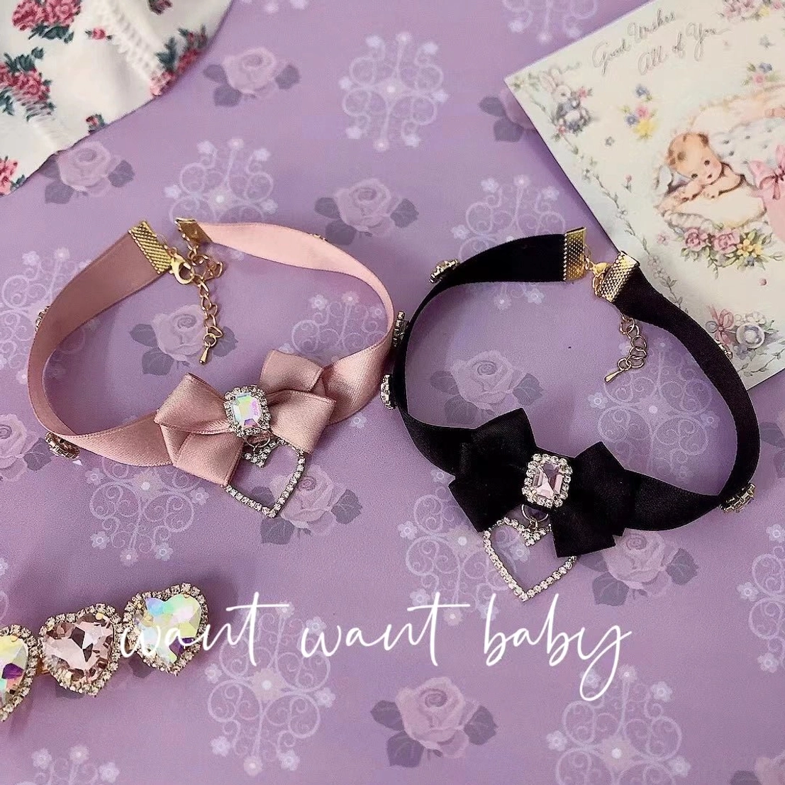 Pink and black bow rhinestone choker necklace options displayed together on vintage purple floral backdrop showing both color variants of this Jirai Kei style accessory
