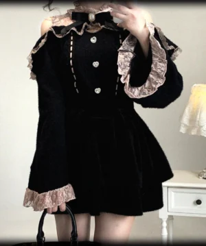 Pink and Black Jirai Kei off-shoulder fuzzy sweater with pink ruffled lace cuffs, heart-shaped buttons and black bow necktie accent, bedroom fashion photography