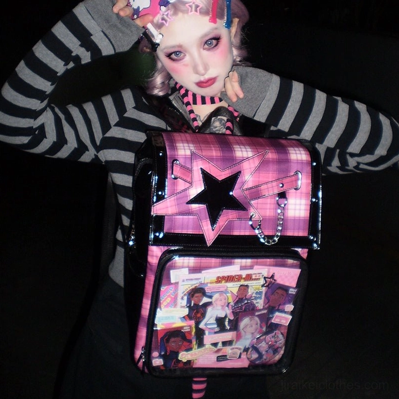 Pink-black plaid star ita backpack close-up with model in indoor setting showing clear display window