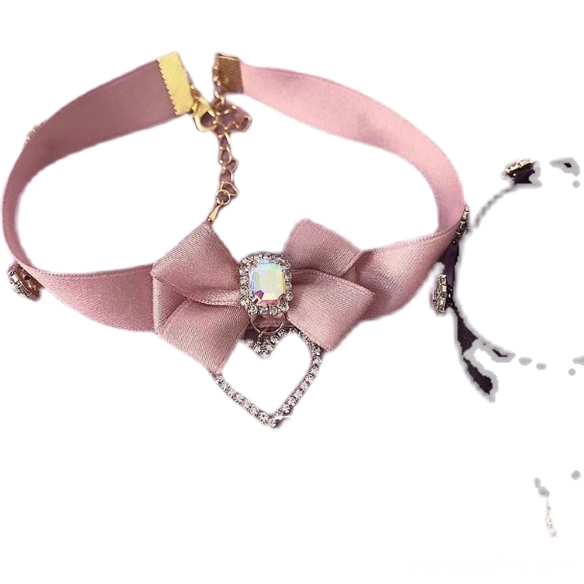 Front view of pink bow rhinestone choker necklace showing satin strap metal hardware and dangling heart-shaped rhinestone pendant charm