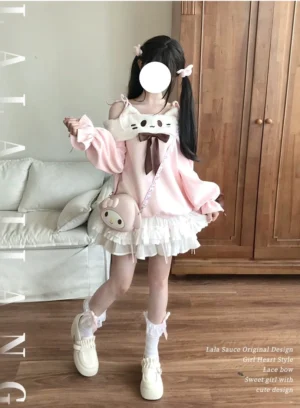 Front full-body view of pink cat off-shoulder sweatshirt with tiered white ruffle skirt, worn by model with twin tails in cozy living room setting, showcasing the complete Jirai Kei outfit coordination