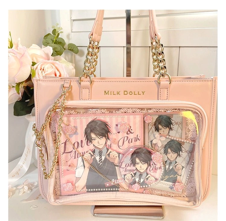 Pink checkered ita bag flat lay on floral desktop with male anime character prints and clear display window