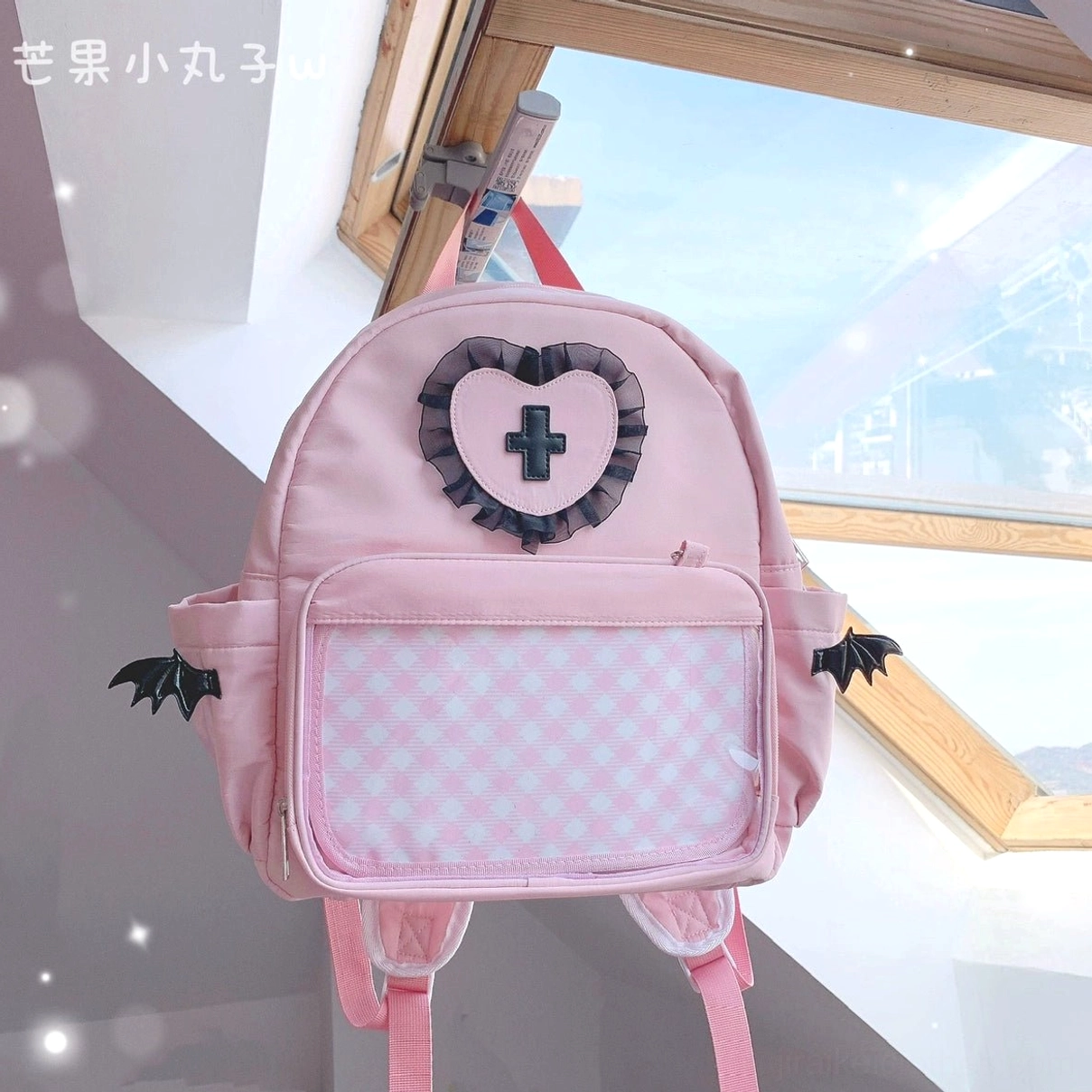Pink evil aesthetic Jirai Kei itabag small size with bold heart lace cross emblem, transparent display pocket and rebellious angel wing decorative accents