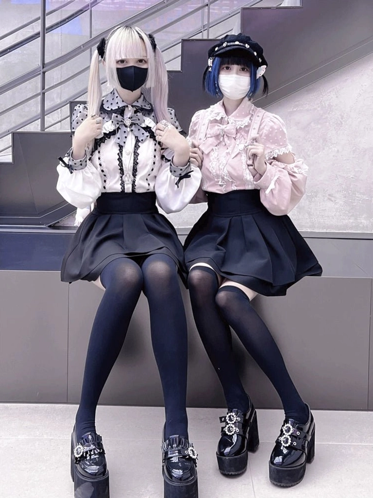 Pink jirai kei off-shoulder blouse with black lace showing rebellious cute fashion subculture style