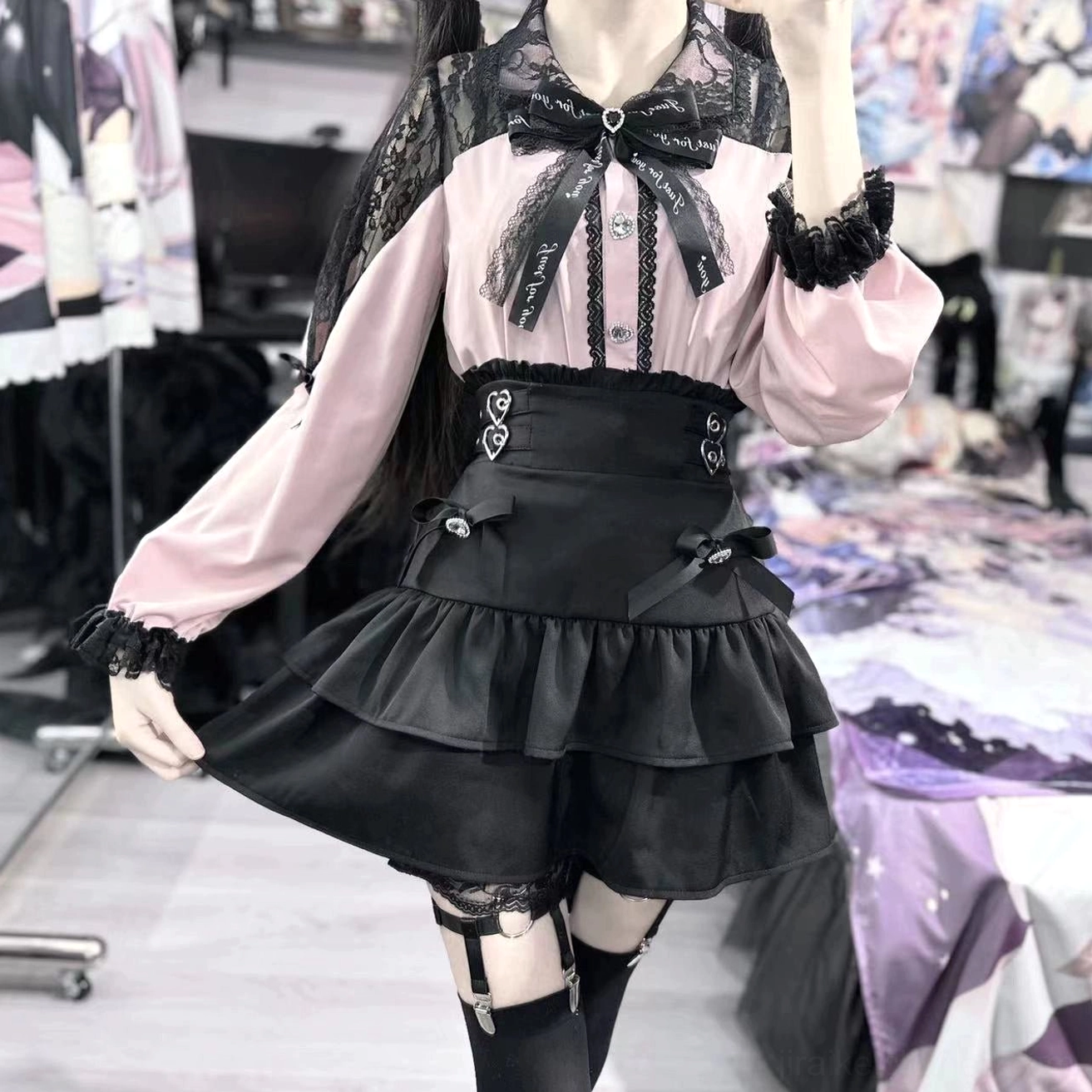 Pink version Jirai Kei blouse and black ruffled skirt set close-up wearing view with lace details and thigh garter accessories