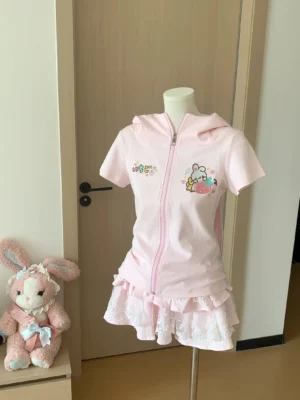 Pink Jirai Kei bunny-ear zip hoodie jacket front view on dress form with embroidered chest bunny motif and cute kawaii aesthetic