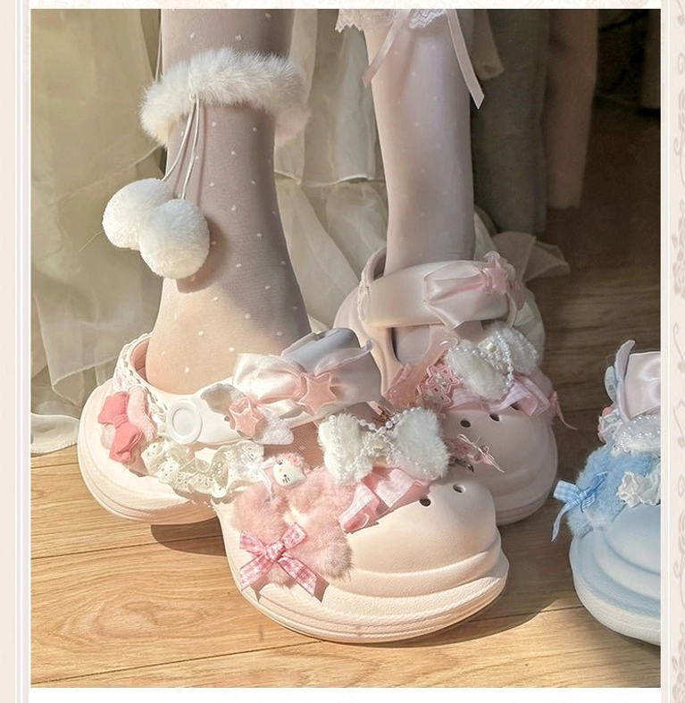 Pink decorative Jirai Kei clog sandal with bow, lace embellishment, matching blue pair visible nearby, frontal close-up with fur pom-pom trim polka-dot socks