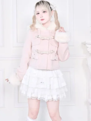 Pink jirai kei hooded rousangata cropped coat with white fluffy fur cuffs, model wearing twin tails hairstyle, front three-quarter view showing bow-accented placket and detachable plush cuffs