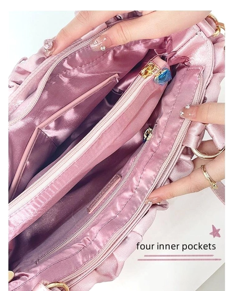Pink Jirai Kei itabag interior held by hands revealing spacious inner compartment with four organizational pockets and zippered main section
