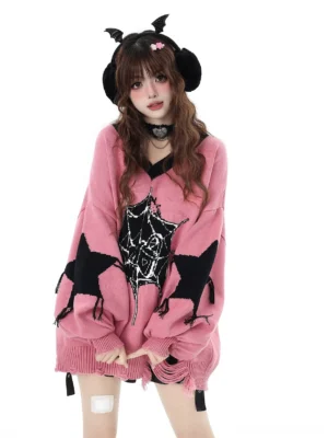 Pink V-neck Jirai Kei knit pullover sweater featuring black star and spider web print with distressed hem worn by model with devil horn earmuffs