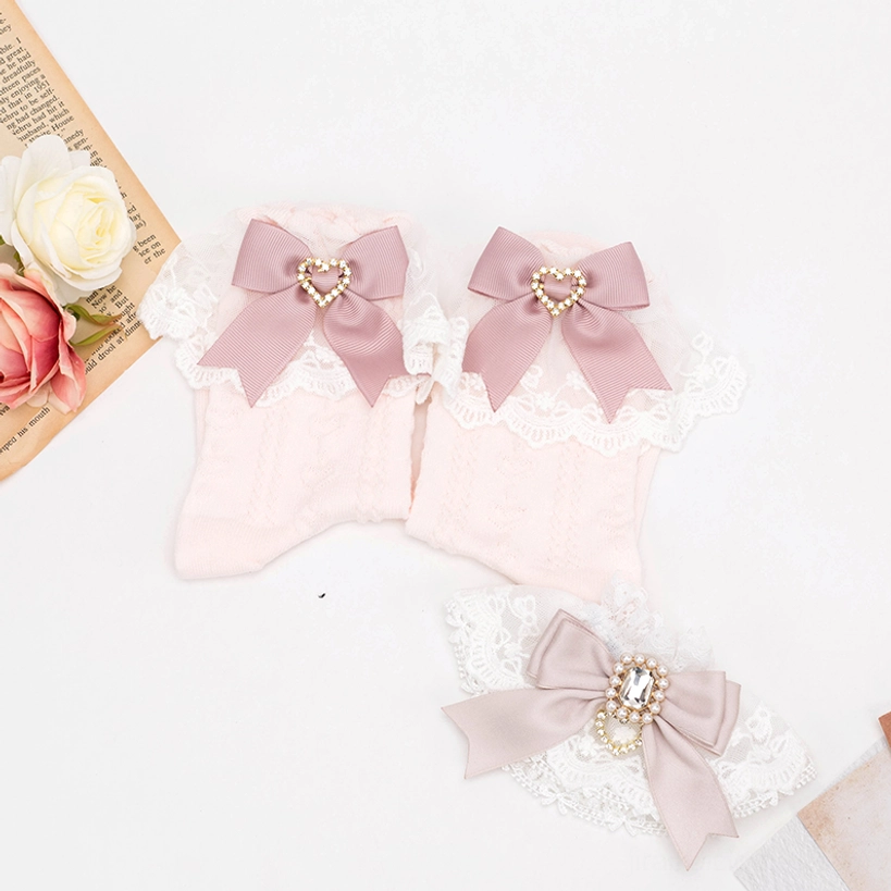 Pink cable-knit Jirai Kei lace socks with lace ruffle cuff and pink heart rhinestone bow embellishment detail