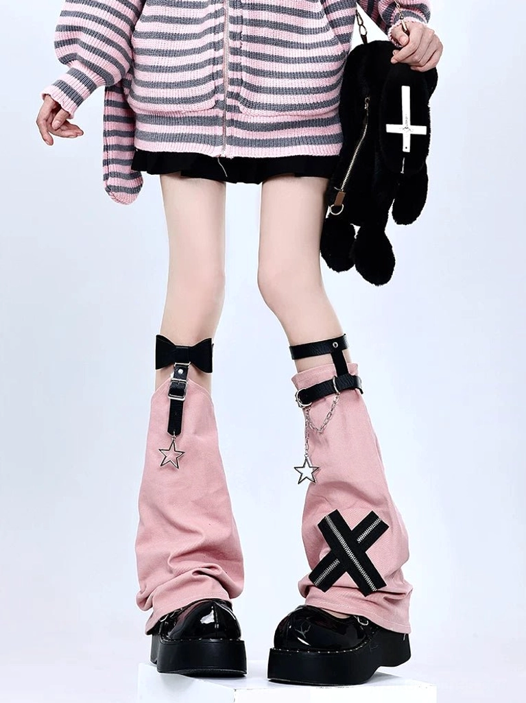 Pink Jirai Kei leg warmers with complete star and chain embellishments, X-zipper design, cross charm, plush bag accessory, pink-gray striped top, black skirt, full styling composition