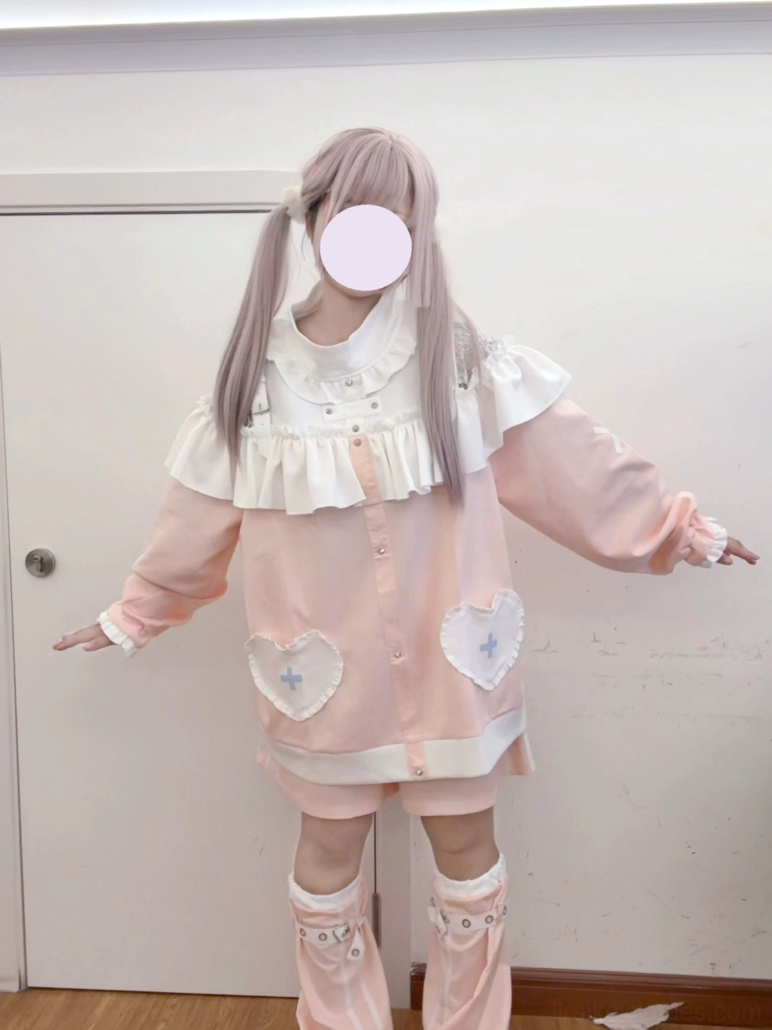 Pink Jirai Kei two-piece lolita outfit side view showing button closure and matching leg warmers with heart-cross therapeutic patches