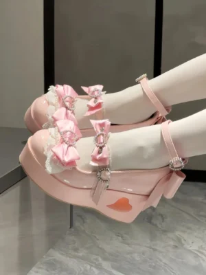 Pink Jirai Kei platform Mary Jane shoes styled on model feet wearing white lace ruffled socks with heart-shaped rhinestone buckles and satin bow trim