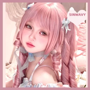 Three-quarter front view of pink double ponytail Jirai Kei wig on model wearing matching sweet Lolita outfit, displaying sakura pink hair color with precision ringlet curls