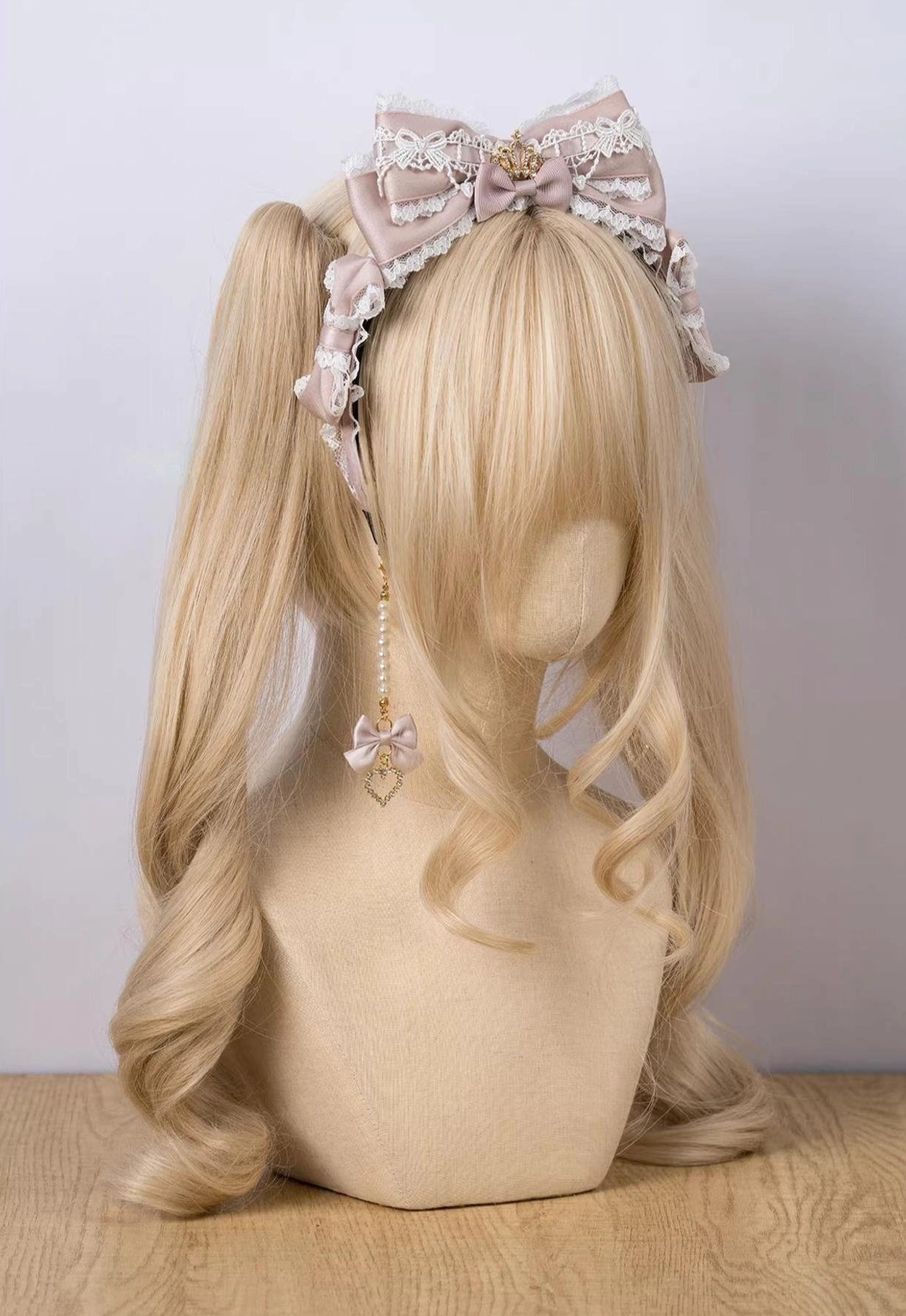 Pastel pink rhinestone crown bow KC Lolita headwear with ruffled lace trim on mannequin front view