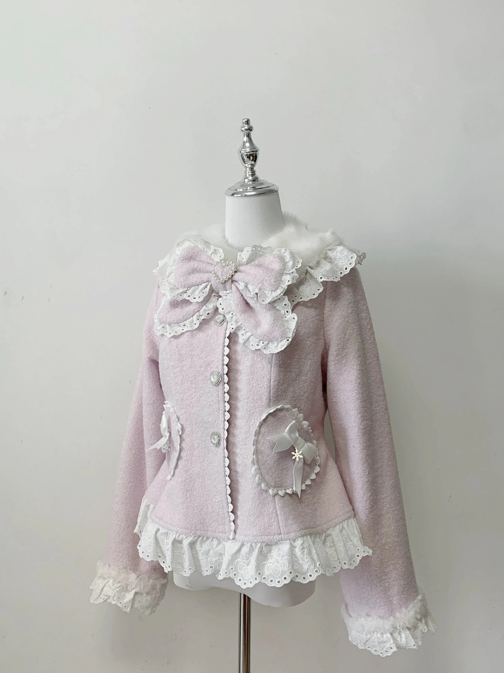 Pink Ryousangata Jirai Kei wool coat with heart-shaped pockets and lace ruffle hem, mannequin flat lay studio display with fuzzy collar detail