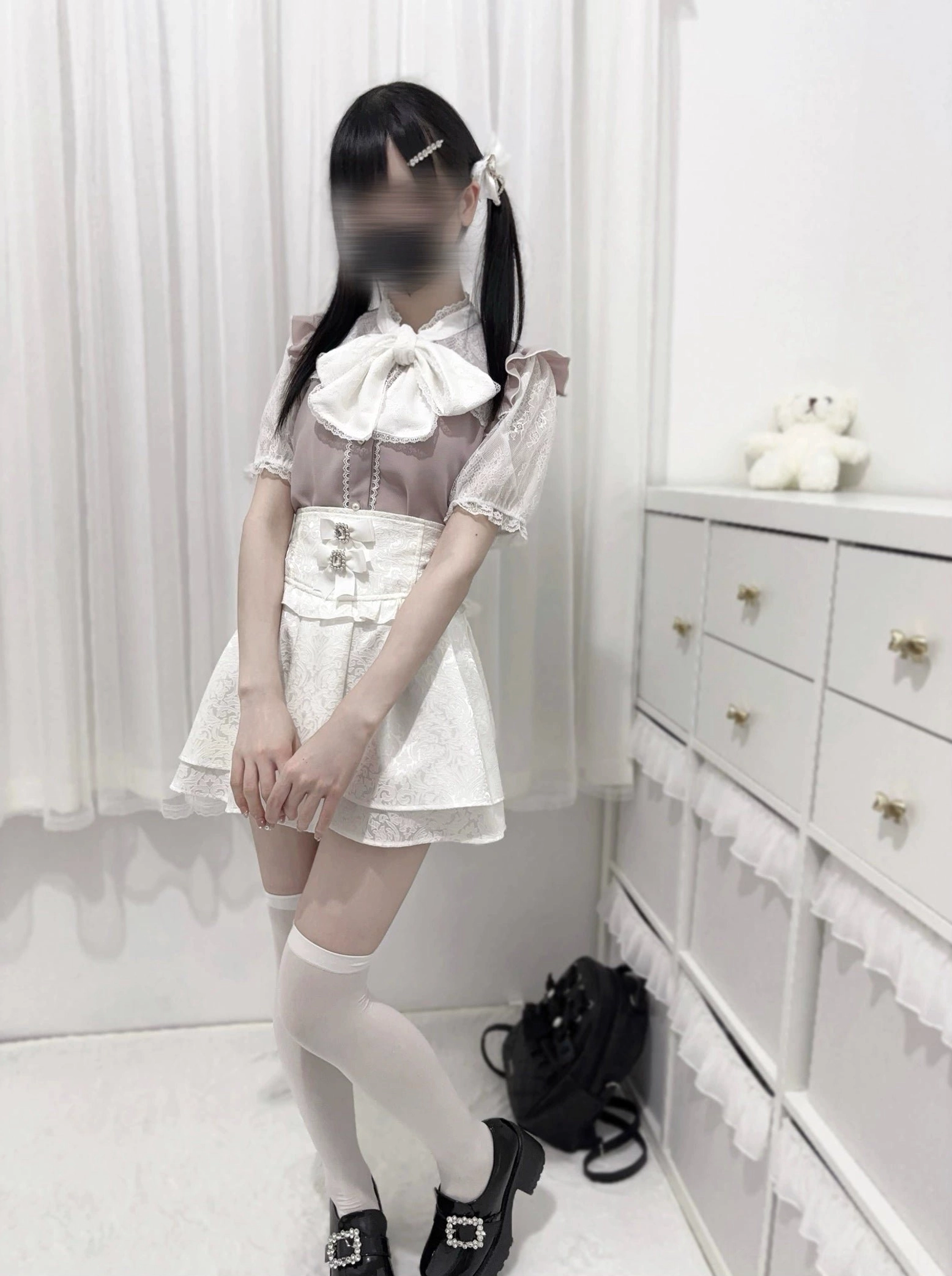 Pink and white color-block jirai kei lace bow blouse front view model standing ruffled lace sleeves decorative waist details