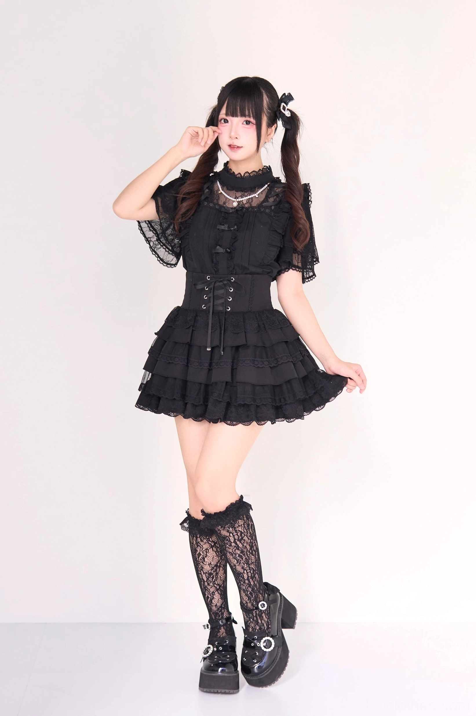 Plaid gingham jirai kei tiered skirt detail close-up showing checkered pattern layered ruffle construction and gothic lolita aesthetic