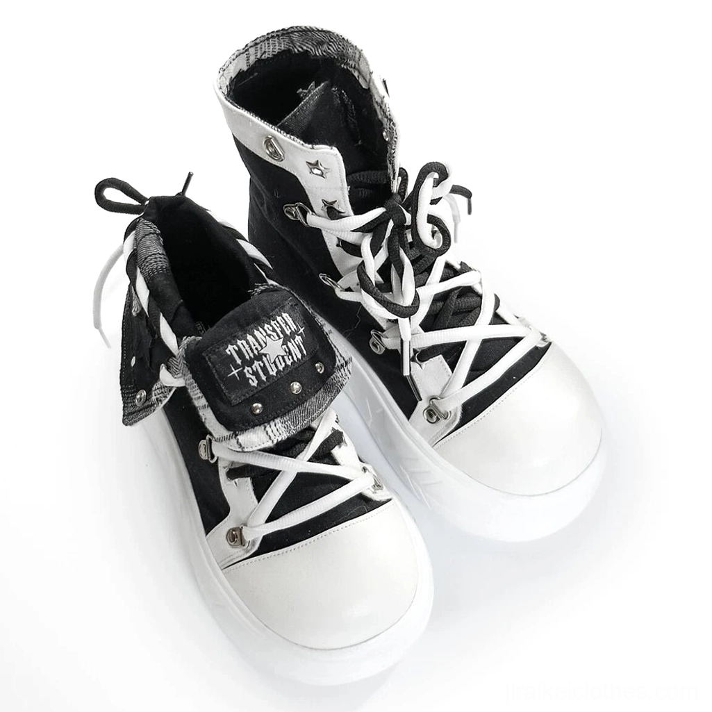 Top-front closeup of black platform canvas high-top sneaker showing foldable collar design with branded embroidered logo strap and contrasting white toe cap detail
