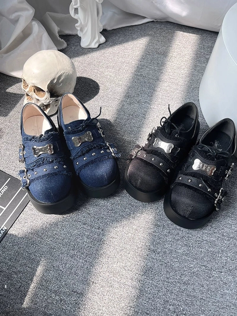 Punk platform shoes jirai kei skull prop flat lay denim blue matte black bone buckles metal straps detailed close-up